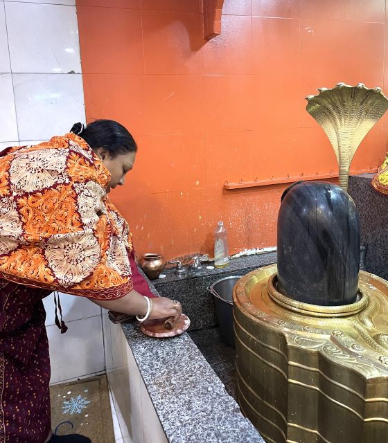 A devotee praying at the Shiva shrine at the Hindu Temple on New Year's Day